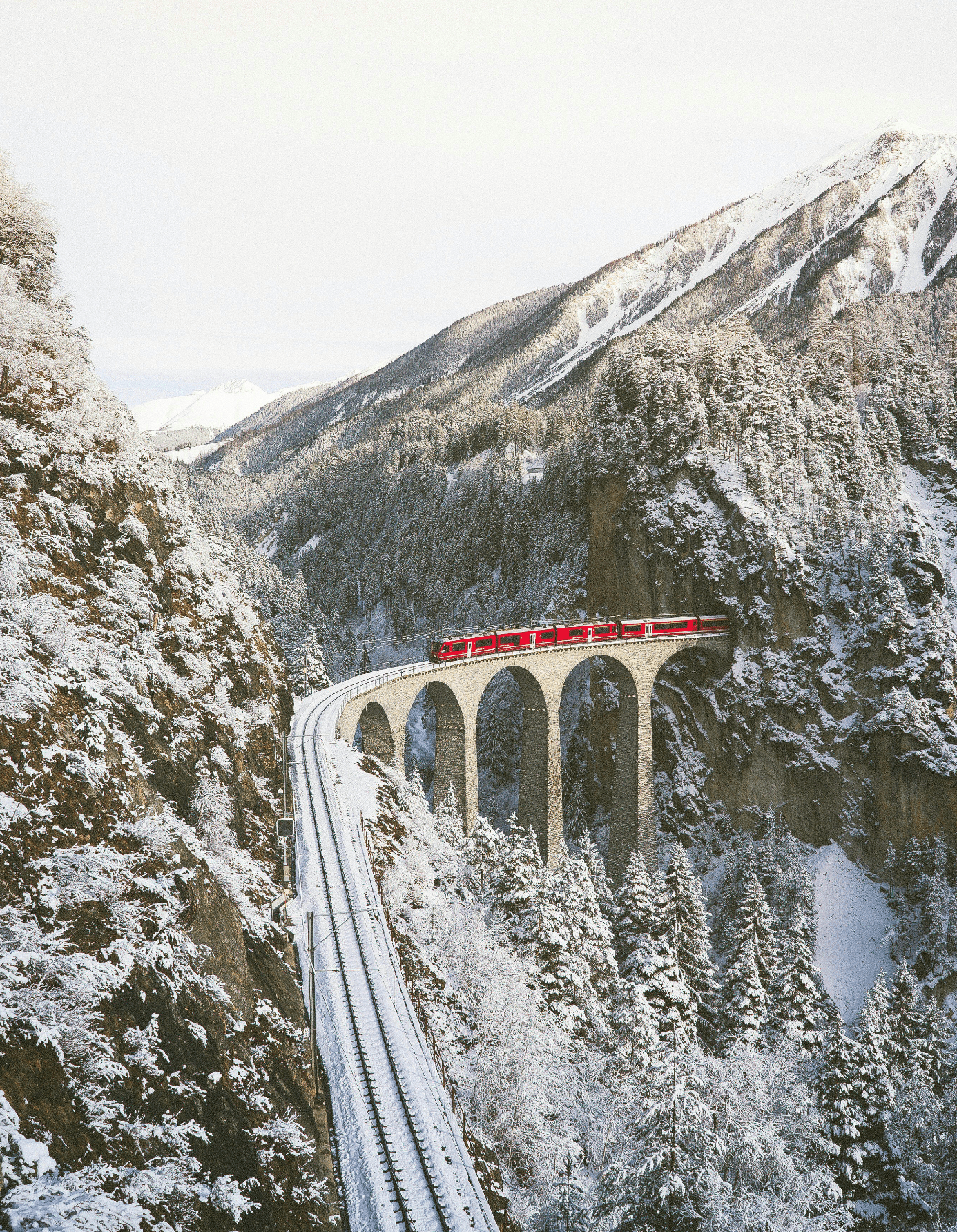 Fotos vom roten Zug, dem Viadukt und den Bündner Landschaften in der Schweiz
