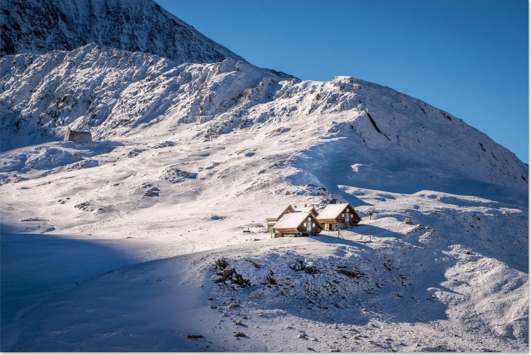 Photos of high-altitude refuges, valleys, snow, and alpine peaks